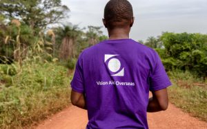 man wearing vision aid overseas t-shirt