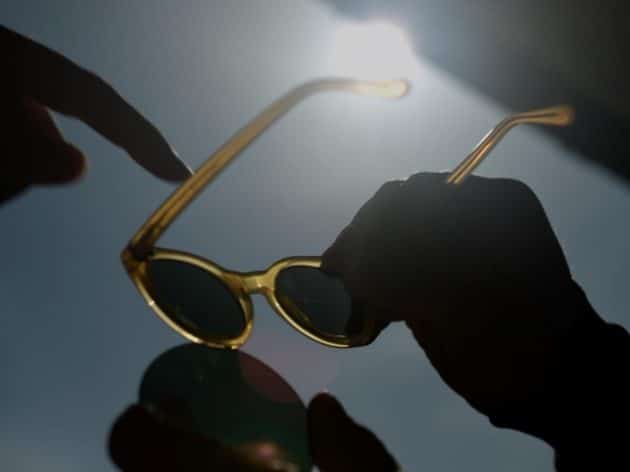 hands holding pair of sustainable Pala sunglasses