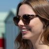 woman wearing round brown tortoiseshell sustainable sunglasses