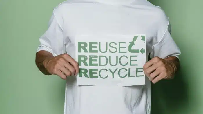 man holding recycle sign