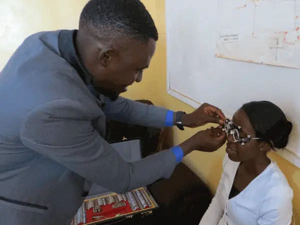 Optometrist performing eyesight examination in Zambia