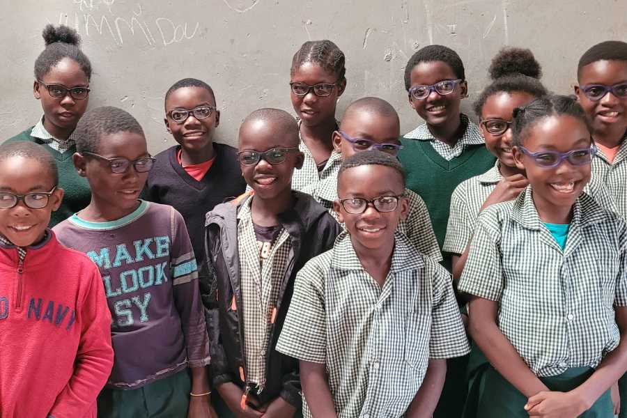 School children in Zambia receiving vision correcting glasses for the first time