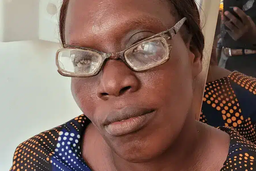 Zambian female teacher Ms Konkola wearing 31-year old broken glasses.