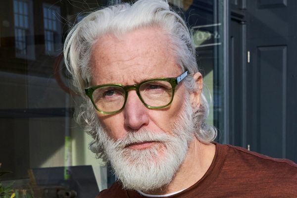 Refined and stylish man wearing emerald green pala spectacles in wimbledon.