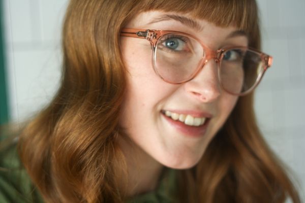 woman wearing pink eco-friendly glasses