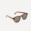 Classic round sunglasses from in transparent tawny brown bio-acetate and grey-green polarised lenses for added clarity.